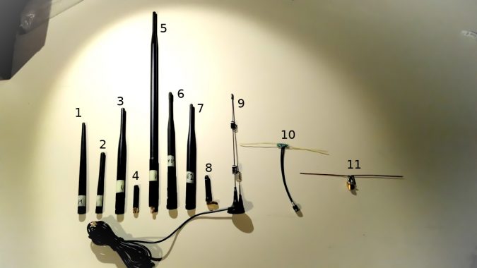 11 different antennas labelled with numbers lined up on a table