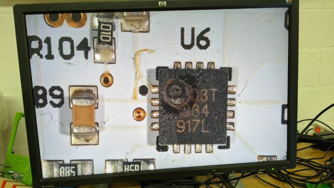 Destroyed electronic component with a hole in the plastic package.